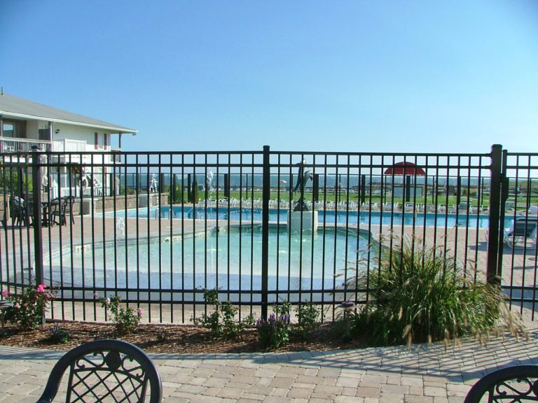 black aluminum fence around a hotel pool overlooking the ocean