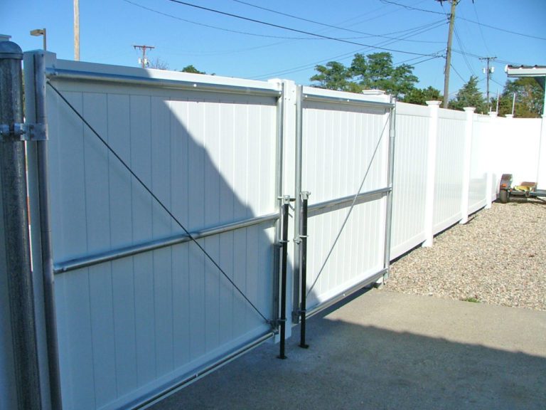 white vinyl commercial fence with a steel framed gate