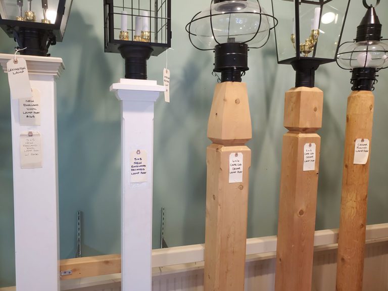 several wood and vinyl lamp posts on display