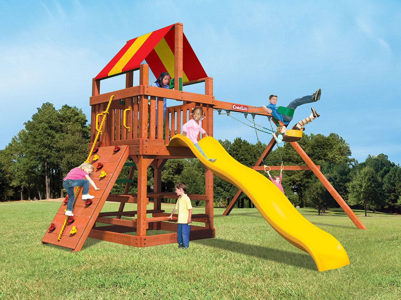 children playing on a gym playset in a yard with trees in the background