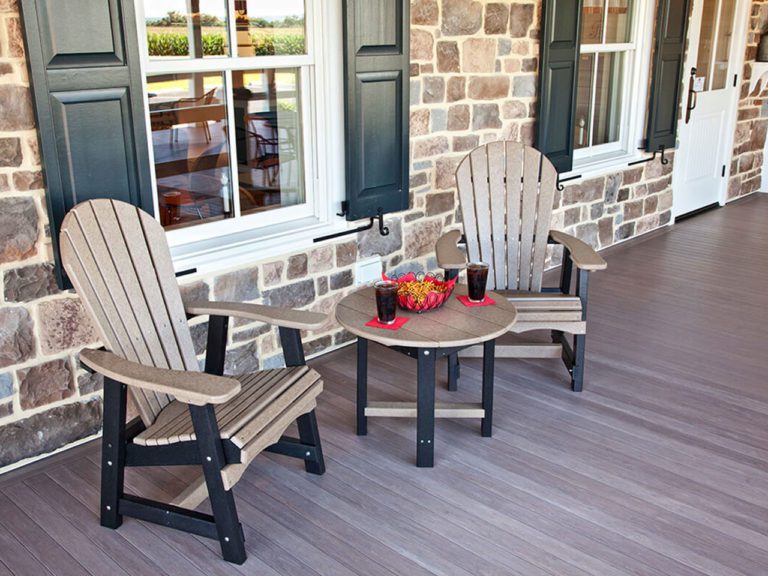 two black and tan chairs and a small table on a front porch