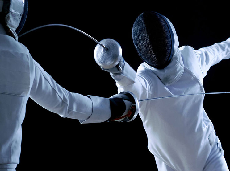 two people fencing with foils